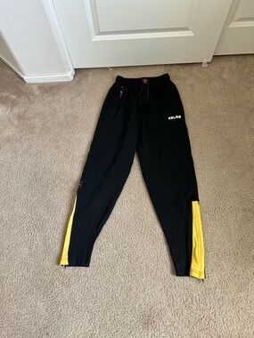 Kelme Men's Black Joggers with Yellow Side Panels
